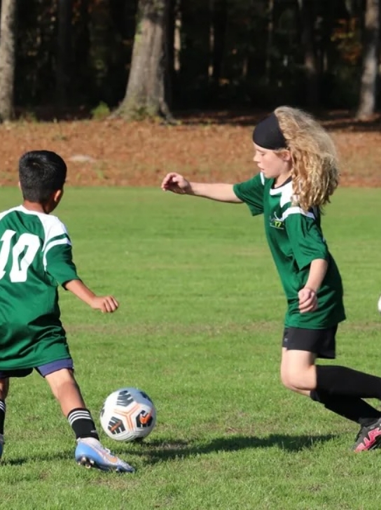Two young players in green jerseys competing during a TM17pro scouting day.