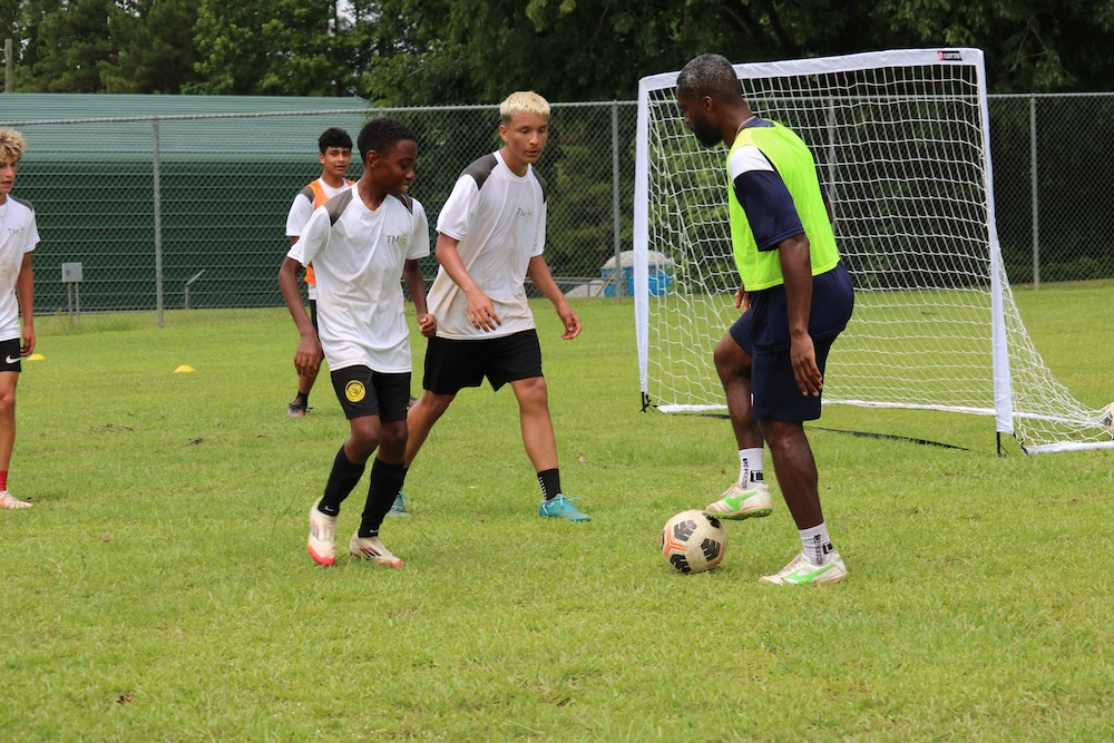 Soccer player with coach on our soccer camp in Charleston, SC